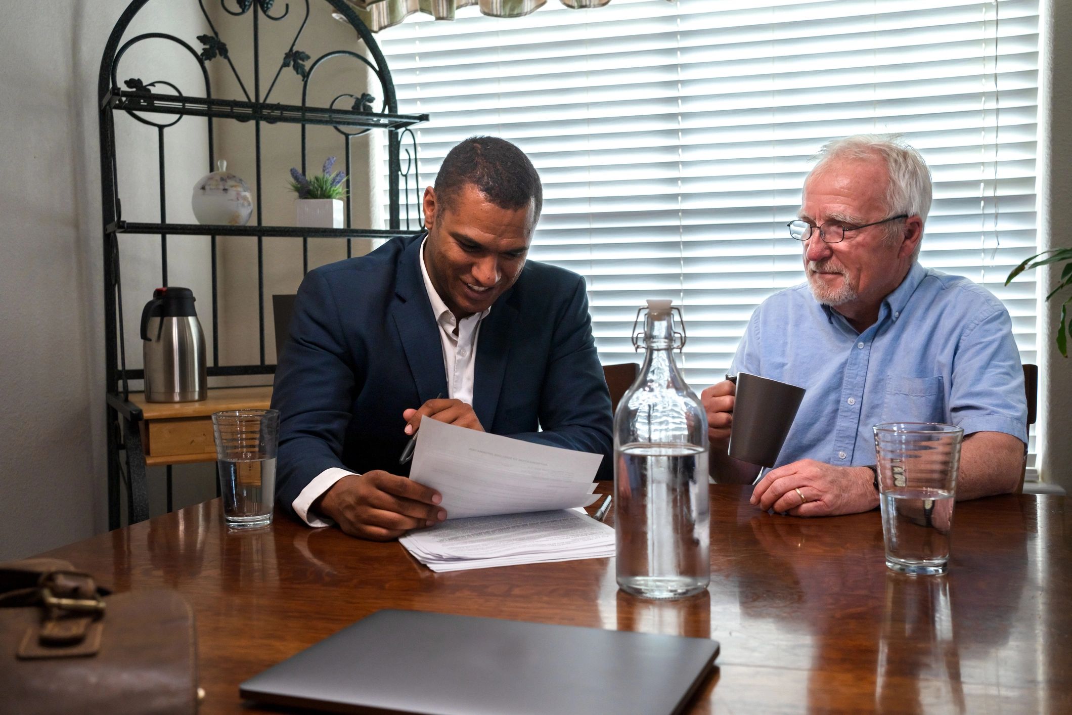 Coach and client in a thoughtful conversation at a table