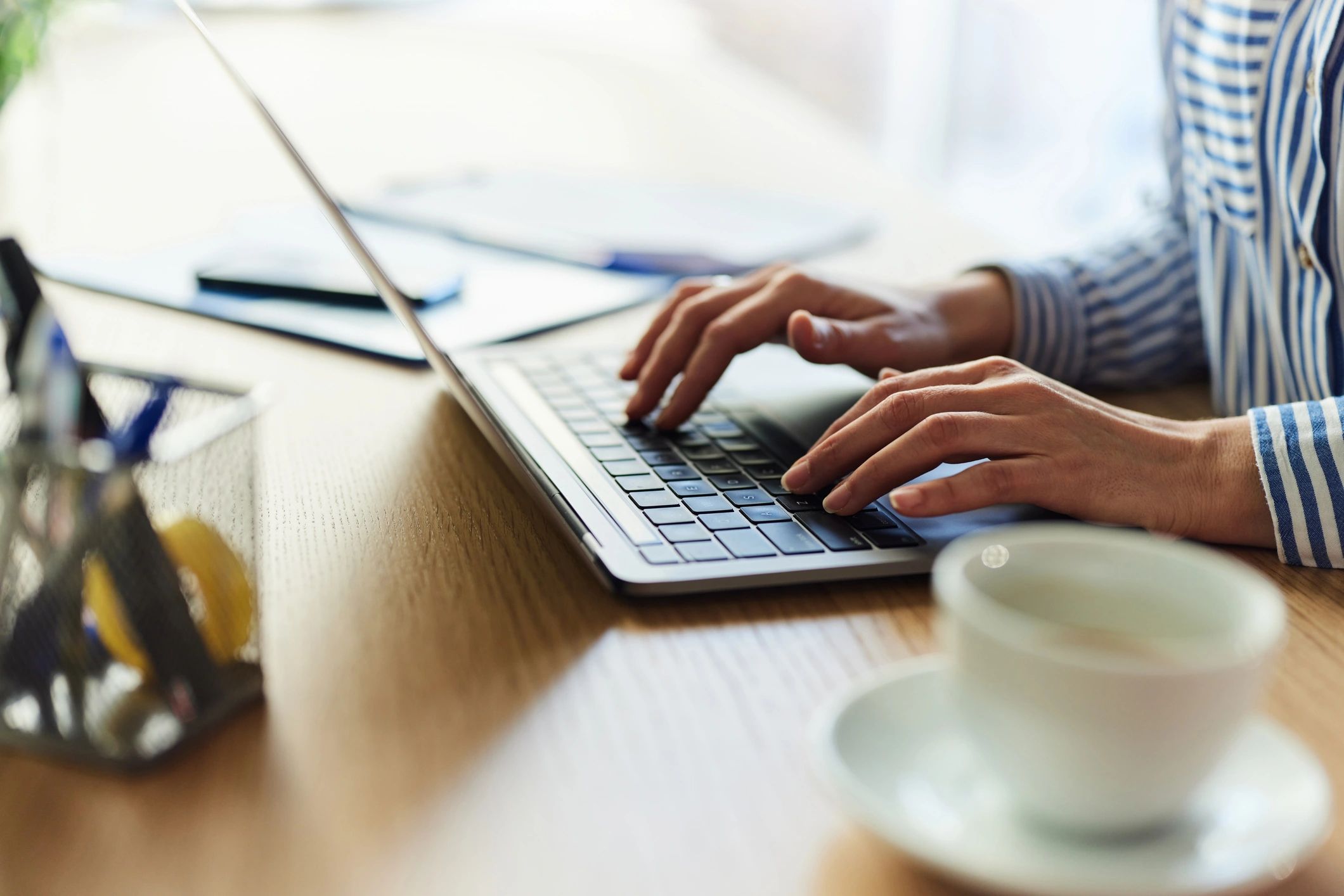 Person typing on a laptop while working